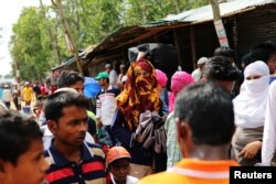 Formin Akter waits for a tuk-tuk as she heads to Chittagong to attend school at the Asian University for Women, in Cox's Bazar, Bangladesh, Aug. 24, 2018.