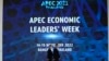Thai officers walk in front of a sign of Asia-Pacific Economic Cooperation (APEC) in Bangkok, Nov. 14, 2022.