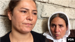 Alia looks on while her mother speaks to a VOA reporter pleading that the international community helps rescue the rest of the captive Yazidi men, women and children, including her other daughters, on the outskirts of Dohuk, northern Iraq, Aug. 2015. (Sharon Behn/VOA)