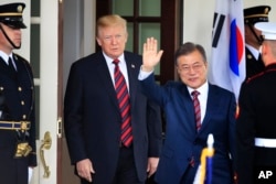 FILE - South Korean President Moon Jae-in waves as he is welcomed by U.S. President Donald Trump to the White House in Washington, May 22, 2018.
