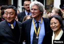 FILE - Actor and activist Richard Gere is flanked by and Lodi Gyari, left, special envoy of the Dalai Lama and Tsering Jampa, right, Chairman of the ICT after the Geuzen Penning ceremony in Vlaardingen, The Netherlands, March 12, 2005.