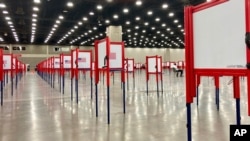 FILE - Voting stations are set up for a primary election at the Kentucky Exposition Center, in Louisville, Kentucky, June 22, 2020.