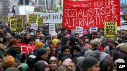 Protesters walk during a demonstration against the new Austrian government in Vienna, Austria, Jan. 13, 2018.