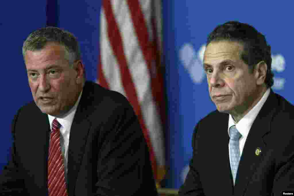 New York City Mayor Bill de Blasio (left) and New York Gov. Andrew Cuomo discuss the city's first confirmed Ebola case at a news conference at Bellevue Hospital, New York City, Oct. 23, 2014. 
