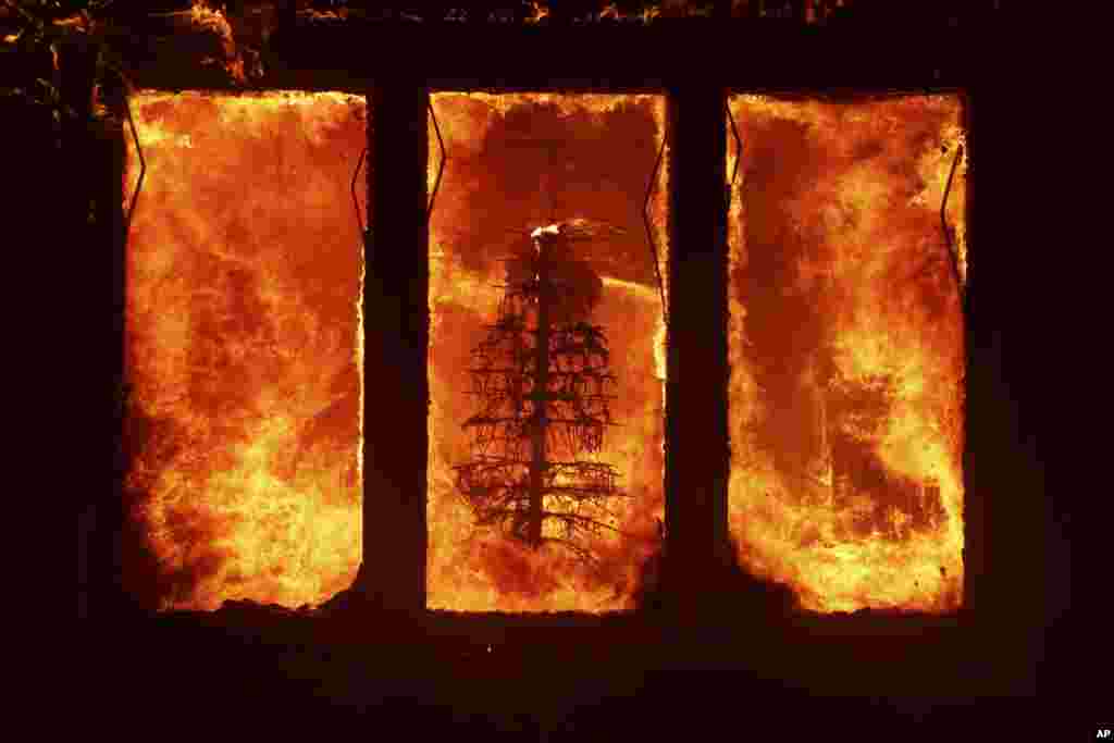 The Palisades Fire burns a Christmas tree inside a residence in the Pacific Palisades neighborhood of Los Angeles, California, Jan. 7, 2025.