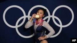 Sunisa Lee, of United States, reacts as she poses for a picture after winning the gold medal in the artistic gymnastics women's all-around final at the 2020 Summer Olympics, Thursday, July 29, 2021, in Tokyo, Japan. (AP Photo/Gregory Bull)