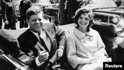 Former United States President John F. Kennedy and first lady Jackie Kennedy sit in a car in front of Blair House during the arrival ceremonies for Habib Bourguiba, president of Tunisia, in Washington, in this handout image taken on May 3, 1961.