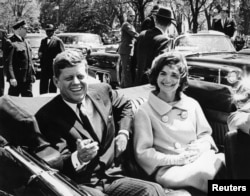 Former United States President John F. Kennedy and first lady Jackie Kennedy sit in a car in front of Blair House during the arrival ceremonies for Habib Bourguiba, president of Tunisia, in Washington, in this handout image taken on May 3, 1961.