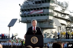 FILE - Then-President George Bush declares the war over in Iraq, May 1, 2003. Behind him on board the carrier USS Abraham Lincoln is a banner reading: "Mission Accomplished."