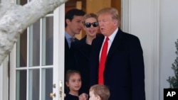 FILE - President Donald Trump and his family, daughter Ivanka Trump, her husband senior adviser Jared Kushner walks out of the Oval Office of the White House.