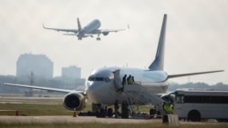 An airplane chartered to transport people to Haiti prepares to board passengers at the San Antonio International Airport as U.S. authorities accelerate the removal of migrants at the border with Mexico, in San Antonio, Texas, Sept. 20, 2021.