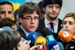 FILE - Fugitive Catalan leader Carles Puigdemont addresses the media in Brussels, Belgium, Jan. 24, 2018.