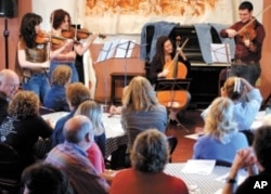 Ed Klorman, director of the Center for Music Entrepreneurship, encourages students to try different venues to showcase their music. Here he performs at one of his Classical Blue Jeans Concerts.