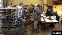 Flint residents pick up bottled water and water filters at a fire station in Flint, Michigan, Jan. 13, 2016.