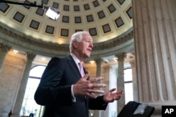 FILE - Majority Whip John Cornyn, R-Texas, takes questions during a TV news interview on Capitol Hill in Washington, April 26, 2018.