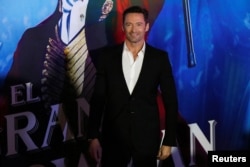 Actor Hugh Jackman poses for photographers on the red carpet for his latest film, a musical directed by Michael Gracey called "The Greatest Showman," in Mexico City, Dec. 13, 2017.