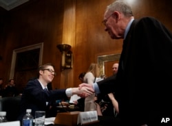 Ethan Lindenberger shakes hands with Senate Health, Education, Labor and Pensions Committee chairman, Sen. Lamar Alexander, R-Tenn., right, before the start of a hearing on Capitol Hill in Washington, March 5, 2019, to examine vaccines.