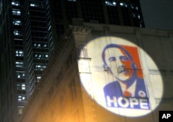 FILE - The poster of the campaign for President-elect Barack Obama is projected on the back wall of the Masonic Lodge Temple Building in Raleigh, N.C., Nov. 4, 2008.