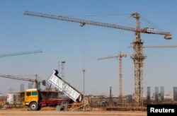 FILE - Constructions machines and workers are seen in Egypt's new administrative capital, north of Cairo, Egypt, Oct. 18, 2017.