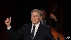 Tony Bennett gestures after singing "I Left My Heart in San Francisco" during a sound check for a Valentine's Day benefit concert in the Venetian Room at the Fairmont Hotel in San Francisco. Bennett returned the hotel to celebrate the 50th anniversary of
