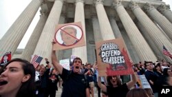 People protest on the steps of the Supreme Court after the confirmation vote of Supreme Court nominee Brett Kavanaugh, on Capitol Hill, Oct. 6, 2018, in Washington.