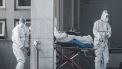 中国湖北省武汉市收治新型冠状病毒肺炎病人的金银潭医院医务人员在运送一名病人。（2020年1月18日）
