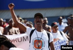 Protesters march past the venue for the World Economic Forum on Africa 2017 meeting in Durban, South Africa, May 3, 2017.