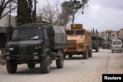 Turkish military vehicles drive in the Syrian rebel-held town of al-Rai, as they head towards the northern Syrian town of al-Bab, Syria, March 2, 2017.