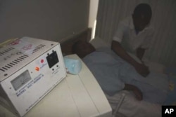 Dr. Motlhabane examines a patient in a ward in Zithulele Hospital