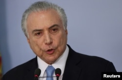 Brazil's President Michel Temer delivers a speech after deputies of the lower chamber of Brazil's Congress voted to reject a corruption charge against him at the Planalto Palace in Brasilia, Brazil, Aug. 2, 2017.