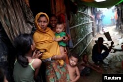 Rohingya refugees are seen outside their makeshift tent in the Kutupalong camp in Cox's Bazar, Bangladesh, Aug. 24, 2018.