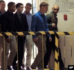 FILE - U.S. Marine Pfc. Joseph Scott Pemberton, third left, is escorted into the courtroom for his scheduled trial, March 23, 2015, at Olongapo city, Zambales province, northwest of Manila, Philippines.