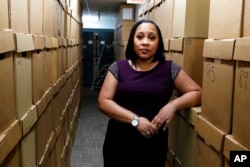 FILE - Fulton County District Attorney Fani Willis is seen at her office, in Atlanta, Feb. 24, 2021.