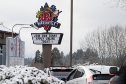 FILE - A sign seeking workers is displayed at a fast food restaurant in Portland, Oregon, Dec. 27, 2021.