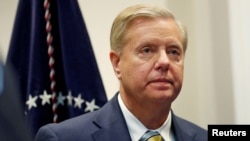 FILE - Sen. Lindsey Graham (R-SC) waits for President Donald Trump to enter the room to speak about the "First Step Act" in the Roosevelt Room at the White House in Washington, Nov. 14, 2018.