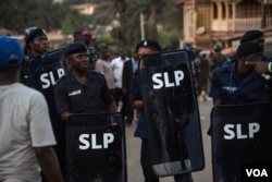 Police hold shields following running battles with supporters of the opposition Sierra Leone People's Party in the Goderich neighborhood of Freetown, Sierra Leone, March 7, 2018. (J. Patinkin/VOA)
