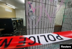 Bullet impacts are seen in the window of a laundromat near the Le Carillon restaurant, one of the attack sites in Paris, Nov. 16, 2015.