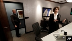 Former Nebraska Lt. Gov. Kim Robak, a Democrat, and her husband, Bill Mueller, a Republican, stand in their office in Lincoln, Nebraska, Jan. 4, 2017.