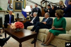 President Donald Trump speaks to, from left, Senate Majority Leader Mitch McConnell, R-Ky., Senate Minority Leader Chuck Schumer, D-N.Y., and House Minority Leader Nancy Pelosi, D-Calif., during a meeting with Congressional leaders in the Oval Office of t