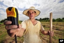 A hand-held satellite device helps a seed collector in Columbia pinpoint wild relatives of stable plants.
