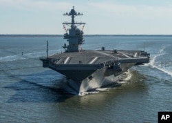 FILE - The USS Gerald R. Ford embarks on the first of its sea trials to test various state-of-the-art systems on its own power for the first time, from Newport News, Virginia, in an undated photo provided by the U.S. Navy.
