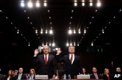 Department of Justice Inspector General Michael Horowitz, left, and FBI Director Christopher Wray are sworn in during a hearing of the Senate Judiciary Committee to examine Horowitz's report of the FBI's Clinton email probe, on Capitol Hill, June 18, 2018.