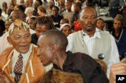 Bushmen leader, Roy Setsana (left), and other Bushmen in court in Gaborone, awaiting the outcome of the case in which they took the Botswana government to court demanding access to a borehole in the CKGR