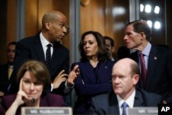 FILE - Senate Judiciary Committee members Sen. Cory Booker, D.-N.J., top left, Sen. Kamala Harris, D-Calif., and Sen Richard Blumenthal, D-Conn., right, talk as Sen. Jeff Flake, R-Ariz., discusses his concerns before the committee on Capitol Hill in Washi