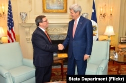 U.S. Secretary of State John Kerry shakes hands with Cuban Foreign Minister Bruno Rodríguez Parilla before their bilateral meeting at the U.S. Department of State in Washington, D.C., July 20, 2015.
