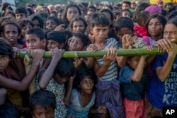 Rohingya Muslim children, who crossed over from Myanmar into Bangladesh, wait to receive aid during a distribution near Balukhali refugee camp, Bangladesh, Sept. 25, 2017.
