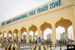 FILE - A security officer takes a selfie at the main gate of Djibouti International Free-Trade Zone after the inauguration ceremony in Djibouti, July 5, 2018.