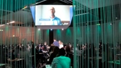 People follow a debate on the opening day of a three-day Youth for Climate summit in Milan, Italy, Tuesday, Sept. 28, 2021. (AP Photo/Luca Bruno)