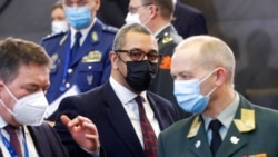Britain's Minister for the Middle East James Cleverly, center, arrives for the NATO-Russia Council at NATO headquarters, in Brussels, Jan. 12, 2022.