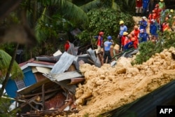 Rescuers search for survivors at the landslide site in Naga City, on the popular tourist island of Cebu, Sept. 20, 2018. At least three people were killed and 10 homes buried early Thursday in the central Philippines when heavy monsoon rains unleashed a landslide.
